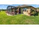 Home exterior showcasing the screened lanai and well-maintained lawn, perfect for outdoor living at 164 Montoro Ln, Davenport, FL 33837