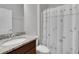 Bright bathroom featuring granite countertop vanity and a shower with decorative curtains at 164 Montoro Ln, Davenport, FL 33837