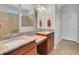 Bathroom with double sinks, granite countertops, and a walk-in shower in neutral tones at 164 Montoro Ln, Davenport, FL 33837