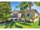 Landscaped home with a lush lawn, a brick driveway, and manicured bushes at 164 Montoro Ln, Davenport, FL 33837