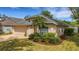 Inviting home features lush landscaping, manicured bushes and a green lawn at 164 Montoro Ln, Davenport, FL 33837