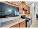 Well-equipped kitchen with granite countertops, backsplash, and modern appliances at 164 Montoro Ln, Davenport, FL 33837