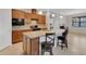 Open concept kitchen island featuring granite countertops with breakfast bar and dark wood cabinets at 164 Montoro Ln, Davenport, FL 33837