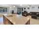 Open concept kitchen island featuring granite countertops with breakfast bar facing living room at 164 Montoro Ln, Davenport, FL 33837
