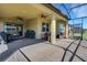Spacious screened lanai with ample seating and a grill, ideal for outdoor dining and entertainment at 164 Montoro Ln, Davenport, FL 33837