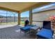 Comfortable screened lanai featuring outdoor seating and a view of the lush backyard at 164 Montoro Ln, Davenport, FL 33837