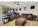 Spacious living room with comfortable leather furniture, tile flooring, and natural light at 164 Montoro Ln, Davenport, FL 33837
