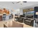Inviting living area with armchairs opening up to the kitchen with granite counters and backyard views at 164 Montoro Ln, Davenport, FL 33837