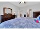 Bright main bedroom showcasing wood furniture, neutral walls, and bathroom and closet access at 164 Montoro Ln, Davenport, FL 33837