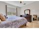 Well-lit main bedroom with a bed, window, dresser with mirror, and ceiling fan at 164 Montoro Ln, Davenport, FL 33837