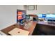 Detailed view of an organized home office with multiple monitors and a spacious desk at 164 Montoro Ln, Davenport, FL 33837