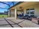 Inviting screened patio with brick floors and comfortable seating area, great for relaxing outdoors at 164 Montoro Ln, Davenport, FL 33837