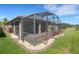 A screened-in patio provides an ideal outdoor living space surrounded by meticulously maintained landscaping at 164 Montoro Ln, Davenport, FL 33837