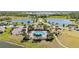 Aerial view of community pool and playground with a parking lot and lakes in the background at 1654 Chatsworth Cir, St Cloud, FL 34771