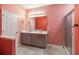 Bathroom with a double sink vanity, large mirror, glass shower enclosure, and tiled floor at 1654 Chatsworth Cir, St Cloud, FL 34771