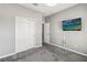 Neutral bedroom with gray carpet, closet, and television mounted on the wall at 1654 Chatsworth Cir, St Cloud, FL 34771