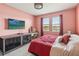 Bedroom featuring tile floors, decorative bedding, two windows, and a TV at 1654 Chatsworth Cir, St Cloud, FL 34771