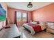 Bedroom featuring tile floors, decorative bedding, two windows, and stylish decor at 1654 Chatsworth Cir, St Cloud, FL 34771