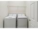 The laundry room features a side-by-side washer and dryer with a wire shelf above at 1654 Chatsworth Cir, St Cloud, FL 34771