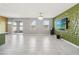 Bright, open-concept living room featuring tile floors, and sliding glass doors at 1654 Chatsworth Cir, St Cloud, FL 34771