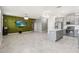 The open living room has an accent wall, tile flooring, and is conveniently near the kitchen at 1654 Chatsworth Cir, St Cloud, FL 34771