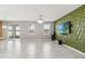 Open living room features a textured accent wall, tile floors, and sliding glass doors to the outside at 1654 Chatsworth Cir, St Cloud, FL 34771