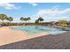 Community pool with clear water, brick patio, and palm trees under a bright sky, inviting relaxation and recreation at 1654 Chatsworth Cir, St Cloud, FL 34771