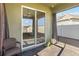 View of the sliding glass doors to the screened in patio, with ceiling fan at 1654 Chatsworth Cir, St Cloud, FL 34771