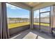 Screened patio with lake view, fan, and ample space for outdoor seating at 1654 Chatsworth Cir, St Cloud, FL 34771