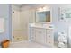 Bright bathroom featuring a glass shower, white vanity with storage, and a neutral color palette at 1923 Lazy Oaks Loop, St Cloud, FL 34771