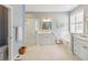 Tranquil bathroom featuring dual vanity, soaking tub, and glass-enclosed shower at 1923 Lazy Oaks Loop, St Cloud, FL 34771