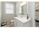 Bathroom vanity with white countertop, window, and view into an adjacent bedroom at 1923 Lazy Oaks Loop, St Cloud, FL 34771