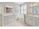 Bright bathroom featuring dual vanities, tub, and glass-enclosed shower at 1923 Lazy Oaks Loop, St Cloud, FL 34771
