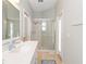 Bathroom with white vanity, glass-enclosed shower, and tile flooring at 1923 Lazy Oaks Loop, St Cloud, FL 34771