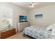 Bedroom featuring a ceiling fan, blue and white patterned quilt, and a wooden chest at 1923 Lazy Oaks Loop, St Cloud, FL 34771