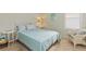 Bright bedroom featuring blue and white quilt, side table, and comfortable chair at 1923 Lazy Oaks Loop, St Cloud, FL 34771