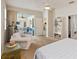Bright primary bedroom featuring a ceiling fan, sliding glass doors to a patio, and an ensuite at 1923 Lazy Oaks Loop, St Cloud, FL 34771