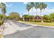 Elegant gated community entrance with brick signage and mature landscaping at 1923 Lazy Oaks Loop, St Cloud, FL 34771