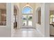 Bright foyer featuring arched entryways, tile flooring, and a glimpse of the home's open and airy layout at 1923 Lazy Oaks Loop, St Cloud, FL 34771