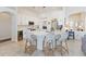 Bright, open kitchen with white cabinets, island seating, and stainless steel appliances at 1923 Lazy Oaks Loop, St Cloud, FL 34771