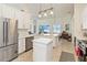 Updated kitchen with stainless steel appliances, island, and an adjacent dining area at 1923 Lazy Oaks Loop, St Cloud, FL 34771