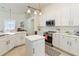 Bright open kitchen with white cabinets, stainless appliances, and a center island at 1923 Lazy Oaks Loop, St Cloud, FL 34771
