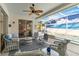 Covered lanai with comfortable seating, ceiling fan, and view of the screened-in pool at 1923 Lazy Oaks Loop, St Cloud, FL 34771