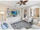 Inviting living room with built-in shelving, comfortable seating, and an arched doorway at 1923 Lazy Oaks Loop, St Cloud, FL 34771