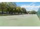 Spacious community tennis court surrounded by mature trees at 1923 Lazy Oaks Loop, St Cloud, FL 34771