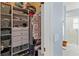 Spacious walk-in closet featuring custom shelves, drawers, and organized hanging spaces at 1923 Lazy Oaks Loop, St Cloud, FL 34771