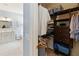 View from walk-in closet with custom shelving and drawers to the ensuite bathroom at 1923 Lazy Oaks Loop, St Cloud, FL 34771