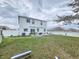 Expansive backyard with lush lawn, patio, and white fencing perfect for outdoor enjoyment and privacy at 2015 Barstow Ln, Dundee, FL 33838