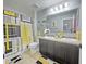 Inviting bathroom featuring a double sink vanity, decorative shower curtain, and coordinating decor at 2015 Barstow Ln, Dundee, FL 33838