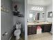 Cozy bathroom featuring tile floors, dark wood cabinetry, and double sinks for added convenience at 2015 Barstow Ln, Dundee, FL 33838